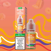 Bottle of Pineapple Peach Mango SKE Crystal Nic Salt e-liquid featuring vibrant tropical-orange packaging adorned with stylized illustrations of pineapple, peach, and mango, accented by frosted ice motifs; includes bold ‘SKE Crystal’ logo and flavor name—formulated as a 50/50 VG/PG nicotine salt for pod-system vaping.
